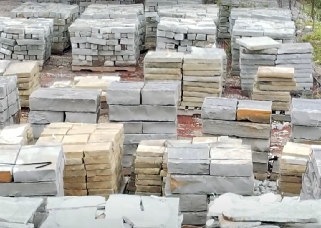 Professional stone and hardscape material selection with various textures and colors organized by type