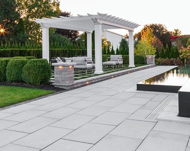 Elegant Patio with White Pergola and Water Feature