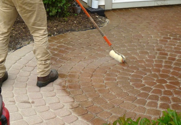 Professional sealer application with roller showing proper technique and coverage