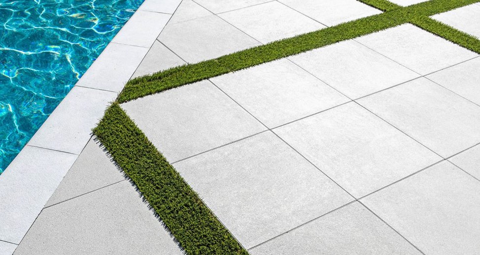 Premium Pool Deck with Decorative Grass Strips - High-End Installation