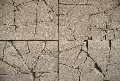 Severely cracked and broken paver tiles showing extensive damage requiring professional repair