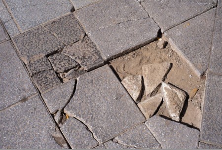 Multiple cracked and broken pavers with significant structural damage requiring replacement